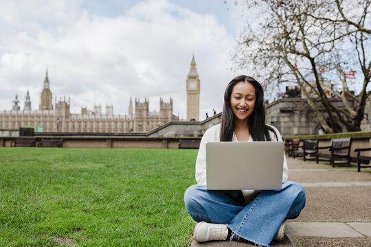 Student working on laptop near Big Ben London