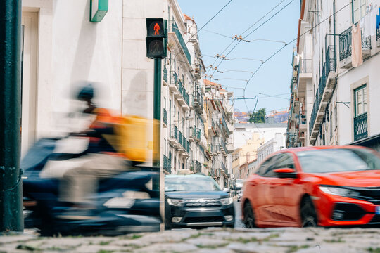 Busy Street Scene in City With Vehicles and Traffic Lights in Motion