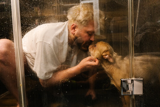 Man Showing Affection To French Bulldog During Bath Time