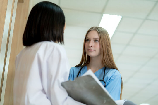 Professional healthcare worker providing attentive consultation with a patient in a clinical setting highlighting patient centered care and effective communication.
