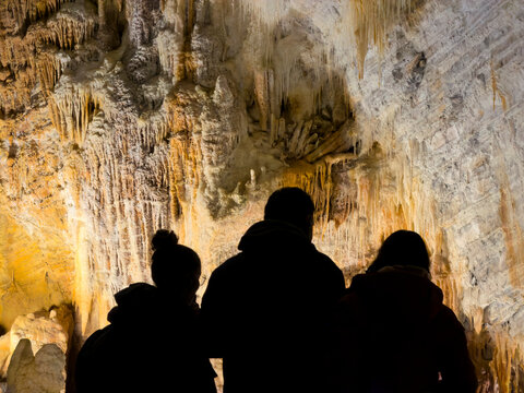 Friends Contemplating Cave Wall Formations