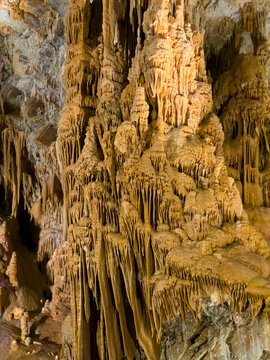 Towering Amber Stalactite Column in Cave