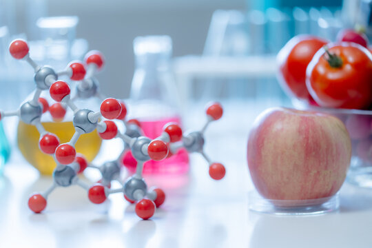 Scientific nutrition research featuring fresh fruits molecular models and laboratory equipment representing healthy food innovation functional nutrition and evidence based wellness.

