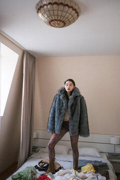 Fashion Model Poses in a Cozy Bedroom With Casual Clothing