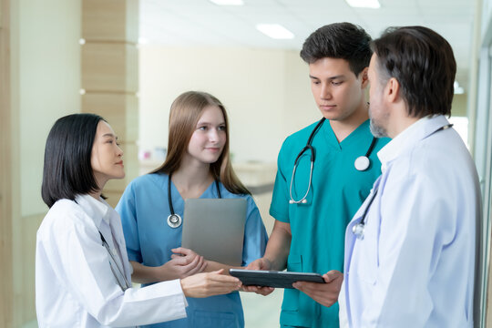 Professional doctors and nurses collaborating with digital devices in a modern hospital showcasing teamwork leadership clinical communication and high quality patient care.
