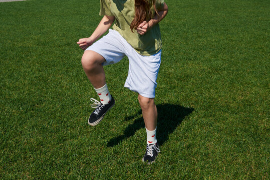 Teenager training on green grass