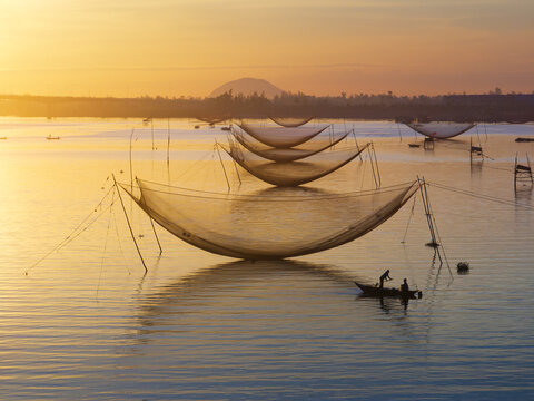 Fisherman Beside Lift Nets