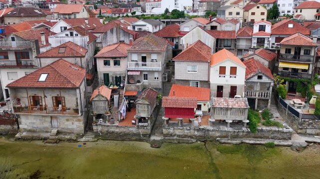 Aerial Drone View of the Coastline and Traditional Stone Horreos in the Historic Village of Combarro Galicia
