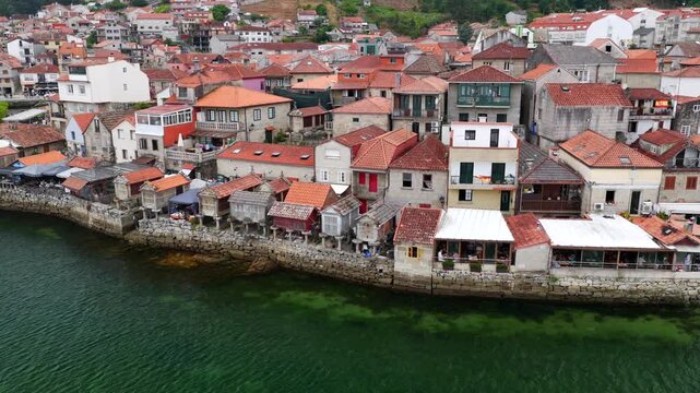 Aerial Drone View of the Coastline and Traditional Stone Horreos in the Historic Village of Combarro Galicia