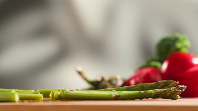 Fresh green asparagus on kitchen with broccoli and green pepper, vegan healthy food. Bunch of green asparagus close-up