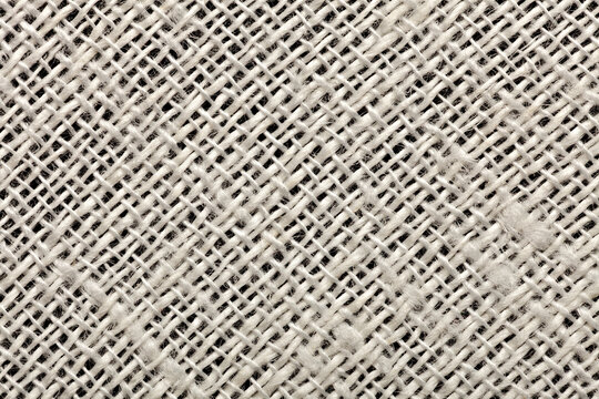 Macro close-up of a natural white 80% linen 20% polyester fabric blend, revealing individual fibers and the fine woven structure in detail for textile and background use.