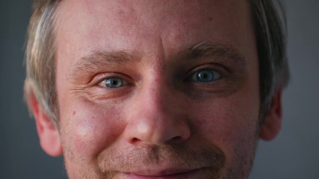 Smiling middle aged man 40 years old standing in office, portrait. Smiling blue eyes office worker, freelancer.