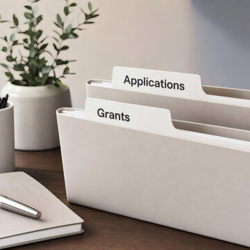 professional neat folders with applications and grants labels on sleek wooden desk organized workspace minimalist