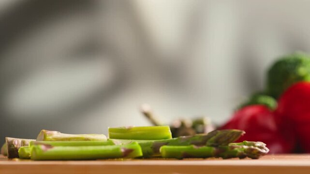 Fresh green asparagus on kitchen with broccoli and green pepper, vegan healthy food. Bunch of green asparagus close-up