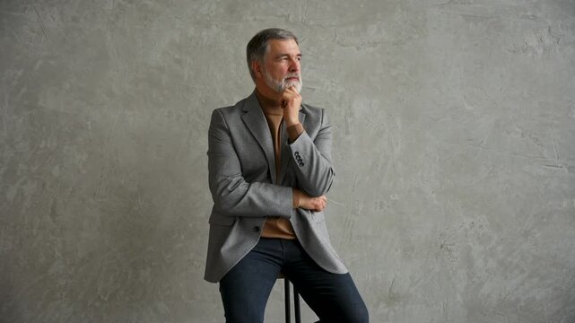Success concept. Stylish bearded man in a suit in modern office