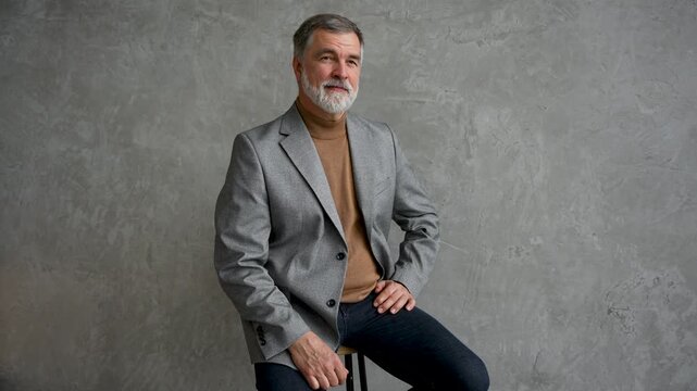 Success concept. Stylish bearded man in a suit in modern office