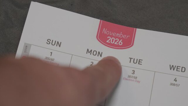 finger pointing at November 2026 planner page close up for scheduling and monthly planning concept