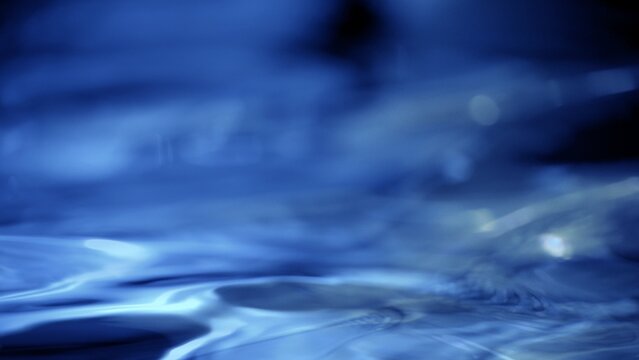Absrtract blue water macro background with gradient liquid on dark backdrop. 3D illustration wave fluid swirling backplate with copy space. Elegant seamless texture.