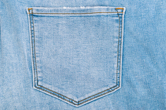 Pocket on blue jeans denim trousers close up