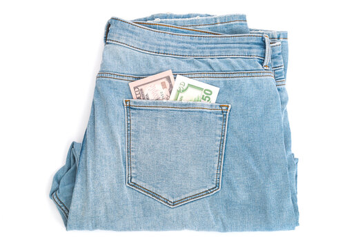Dollars banknotes in pocket by jeans  trousers isolated on white background