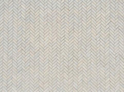 Light grey herringbone paving stones, outdoor ground texture with interlocking bricks, pale pathway surface