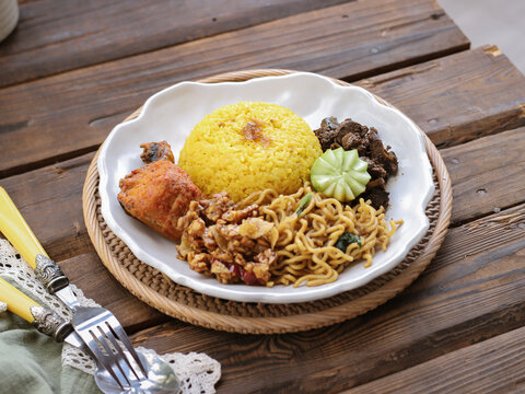 Nasi kuning, Indonesian traditional food, made from rice cooked with turmeric and coconut milk and spicies