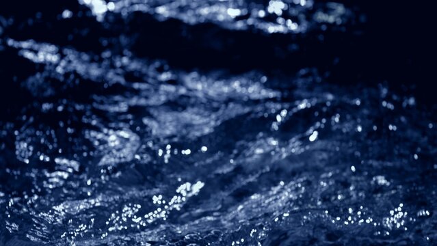 Fresh blue water macro background with splashing liquid on dark black backdrop. 3D illustration wave fluid swirling backplate with copy space. Clean abstract bubbles texture.