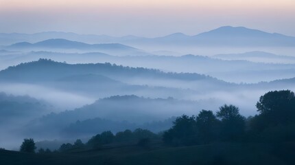 Naklejka premium Layered blue mountain ridges rise above misty forest valleys at dawn, creating a serene scenic backdrop for travel, meditation, or outdoor adventure campaigns.