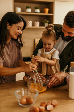 Family enjoying together cooking in modern kitchen at home