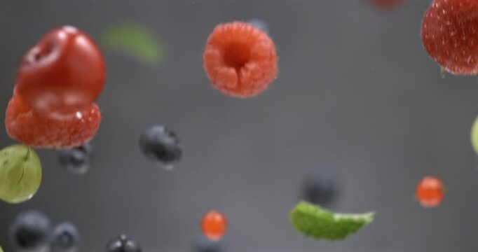Mixed fresh berries floating in super slow motion on black background
