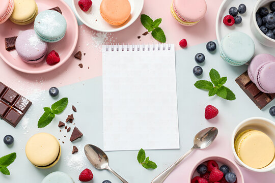 Sweet Dessert Flat Lay with Macarons, Berries, and Baking Ingredients on Pastel Background