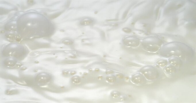 Milk texture with natural bubbles abstract dairy background super slow motion 1000 fps
