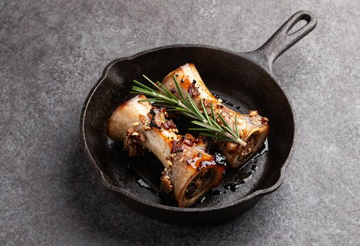 Slow Roasted Bone Marrow in Cast Iron Skillet with Rosemary Sprigs