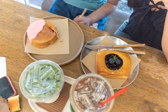 Delicious Pastries and Refreshing Drinks on a Wooden Table