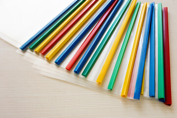 Obraz premium Colored plastic folders lie on the table.