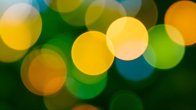 Abstract Background with Soft Multi-Colored Bokeh Circles, Vivid Yellow, Green, and Blue Light Orbs for Festive Holiday Designs, Artistic Texture for Digital Art Projects