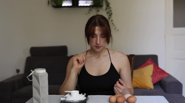 Vertical screen Woman chooses protein powder over eggs believing supplements are an easier way to reach high protein goals than getting enough from whole foods alone