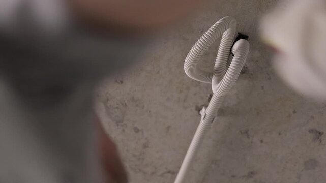 Pulling electrical cable through corrugated conduit in concrete ceiling