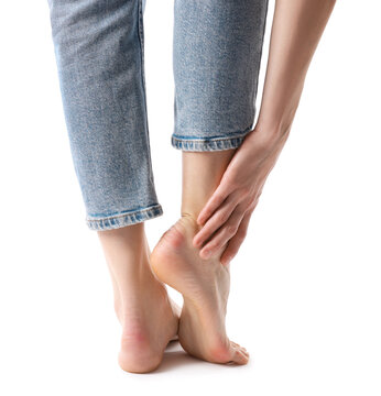 Woman with calluses on her feet against white background, closeup