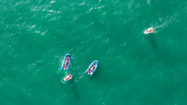 Aerial view of groupes of Optimist Class sailboats before the starting of a regatta in Alicante, in the Mediterranean coast of Spain.