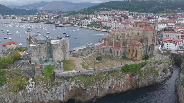 Aerial drone flying over castro urdiales cathedral and lighthouse