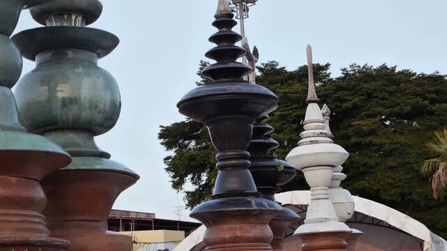 Slow motion panning shot of illuminated Thai temple replica at dusk