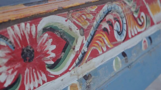 The patterns on the wooden boat are painted with exquisite skill.