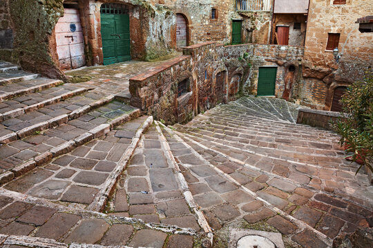 Pitigliano, Grosseto, Tuscany, Italy: ancient stone staircase and alley in the medieval town founded in Etruscan times
