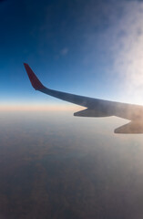 Fototapeta premium View on sunset and airplane wing from the inside