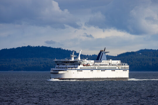 Passenger Ferry At Sea Near Forested Islands In The Strait Of Georgia, British Columbia, Canada