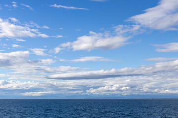 Fototapeta premium Calm Blue Ocean and Dramatic Cloud Sky Over the Strait of Georgia, British Columbia, Canada