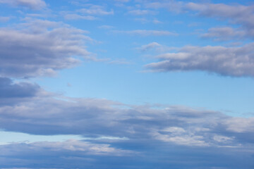 Obraz premium Blue Sky With Soft Gray Clouds Overhead Cloudscape Showing Calm Atmospheric Layers