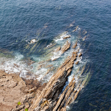 Dramatic cliffs near Bilbao overlooking the turbulent waters of the Bay of Biscay, showcasing the rugged coastal landscape of the Basque Country.