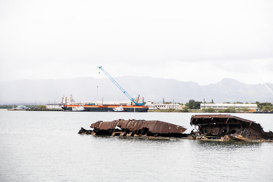 Rusted sunken wreckage in the calm waters of Pearl Harbor, Oahu